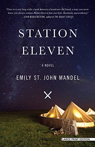 Cover art for 'Station Eleven' by Emily St. John Mandel, Large Print Edition. The image features a starry night sky over a serene campsite with a lit-up tent, symbolizing a quiet, introspective moment in a novel known for its themes of survival and the enduring qualities of human culture.