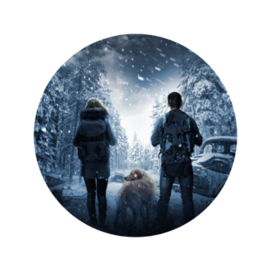 Two people and a dog standing in the snow